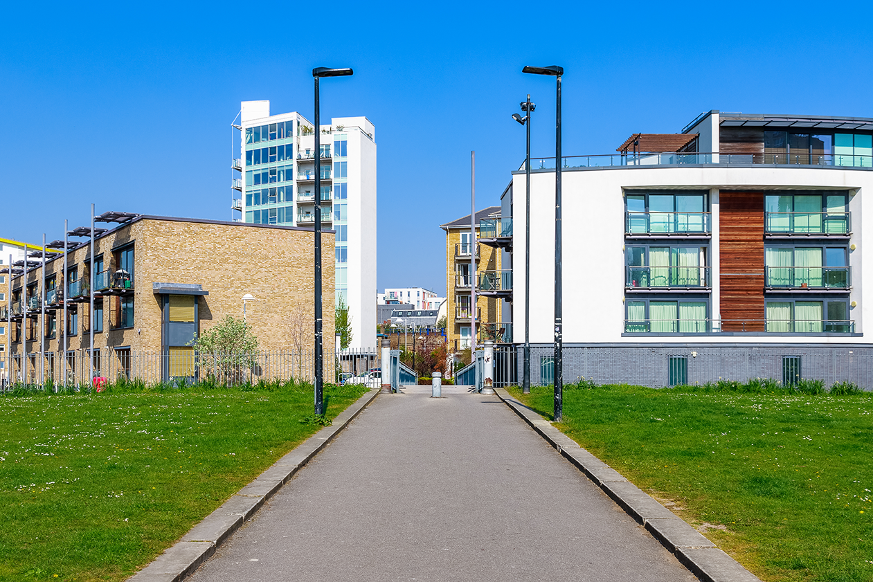 A photo of a contemporary building development with green space